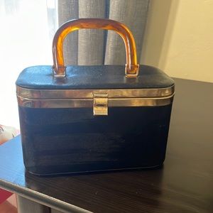 Vintage black leather purse with tortoise handle.